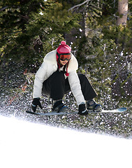 Image showing Snowboarding in a forest