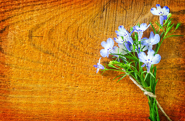 Image showing flowers on wooden background