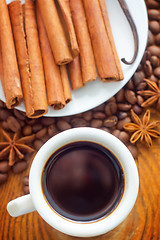 Image showing Fresh aroma coffee in the white cup, coffee and cinnamon