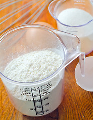 Image showing Sugar, flour and raw eggs on the wooden board