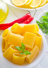 Image showing raw pasta with aroma spice and oil in the bottle