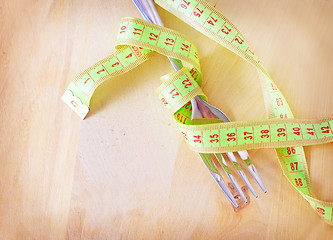 Image showing metr and fork on the wooden board