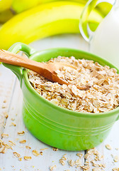 Image showing Oat flakes in the green bowl with banana and milk