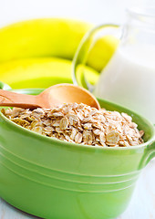 Image showing Oat flakes in the green bowl with banana and milk