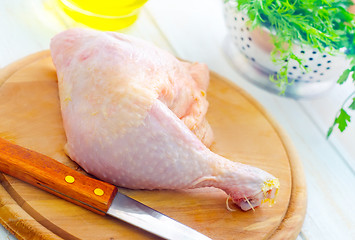 Image showing Raw chicken and knife on the wooden board