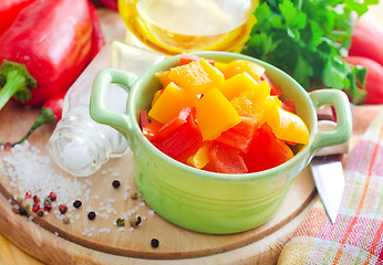 Image showing Color peppers on the wooden board, pepper and knife