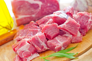 Image showing raw meat and knife on the wooden board