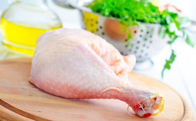 Image showing Raw chicken and knife on the wooden board