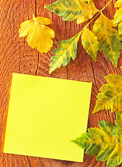 Image showing note and leaves on wooden background