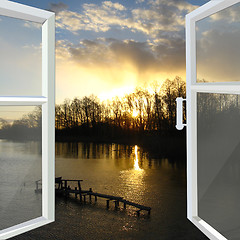 Image showing window opened to the river with sunset