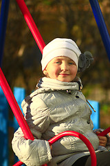Image showing little girl plays on the swing
