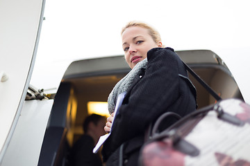 Image showing Woman boarding airplain.