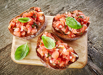 Image showing toasted bread with chopped tomatoes