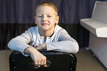 Image showing Boy near white piano