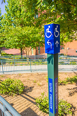 Image showing blue handicapped wheel chair post sign