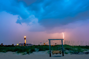 Image showing tybee island beach lighthouse with thunder and lightning