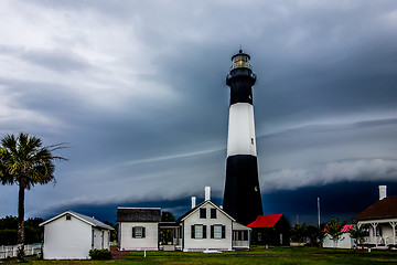 Image showing tybee island beach lighthouse with thunder and lightning