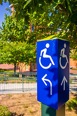 Image showing blue handicapped wheel chair post sign