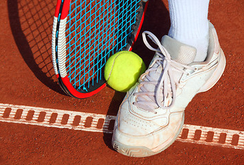 Image showing Legs of man near the tennis racquet and balls