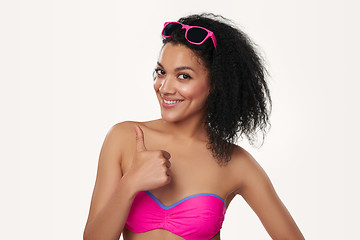 Image showing Smiling woman in swimsuit gesturing thumb up