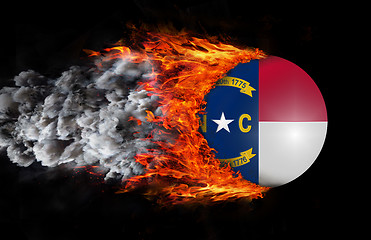 Image showing Flag with a trail of fire and smoke - North Carolina