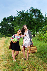 Image showing Two girls getting ready for a picnic