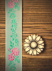 Image showing vintage aqua color tape with embroidered ornaments and old butto