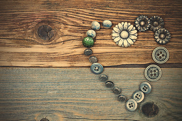 Image showing vintage buttons heart on old textured boards