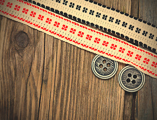 Image showing two vintage ribbons with embroidered ornaments and old buttons