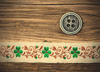 Image showing vintage band with embroidered ornaments and old button