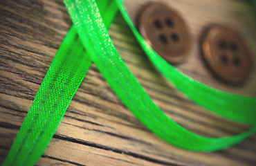 Image showing still life with old green tape and two vintage buttons