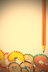 Image showing striped pencil and colored shavinsg