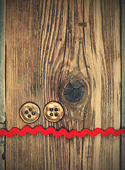 Image showing still life with old red tape and two vintage buttons