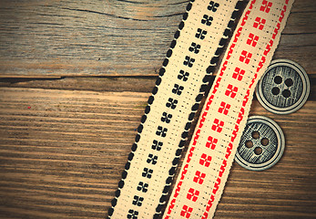 Image showing antique ribbons with embroidered ornaments and old buttons