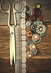 Image showing aged buttons, lace and a tailor scissors
