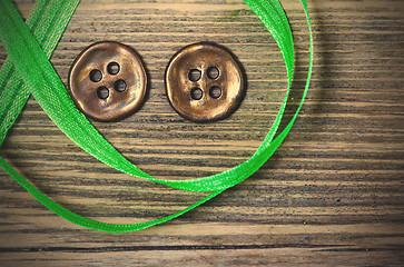 Image showing still life with old green tape and two vintage buttons