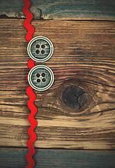 Image showing vintage red tape and two old classic buttons