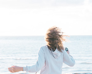 Image showing energetic female moving by the ocean