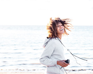 Image showing energetic female moving by the ocean