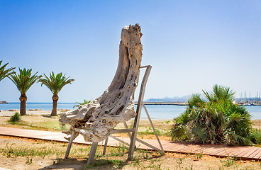 Image showing Decorative ornaments out of the trunk of an old tree by the sea.