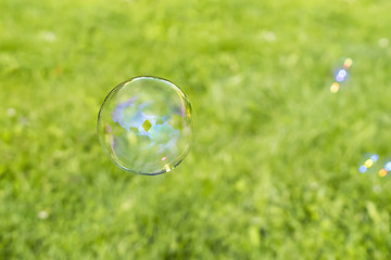 Image showing Clear bubbles on grass background