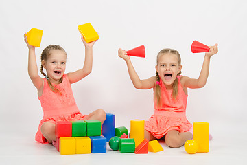 Image showing Two girls having fun playing with blocks