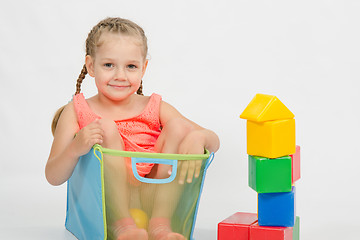 Image showing The girl climbed into a box for toys