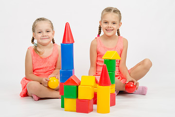 Image showing Happy two girls built a castle out of blocks