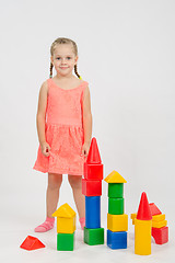 Image showing Four-year girl has built a few houses out of blocks