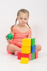 Image showing The child does not know where to put ball in house