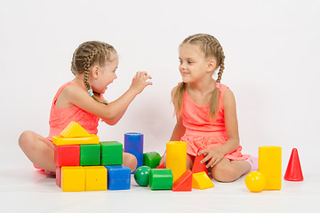 Image showing Girl frighten another girl playing with blocks