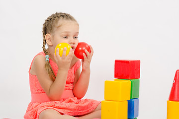 Image showing Child being played in developing a set of put two balls to the cheeks