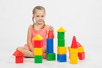 Image showing Child cheerfully plays with blocks