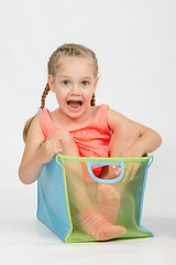 Image showing Happy girl in a box for toys